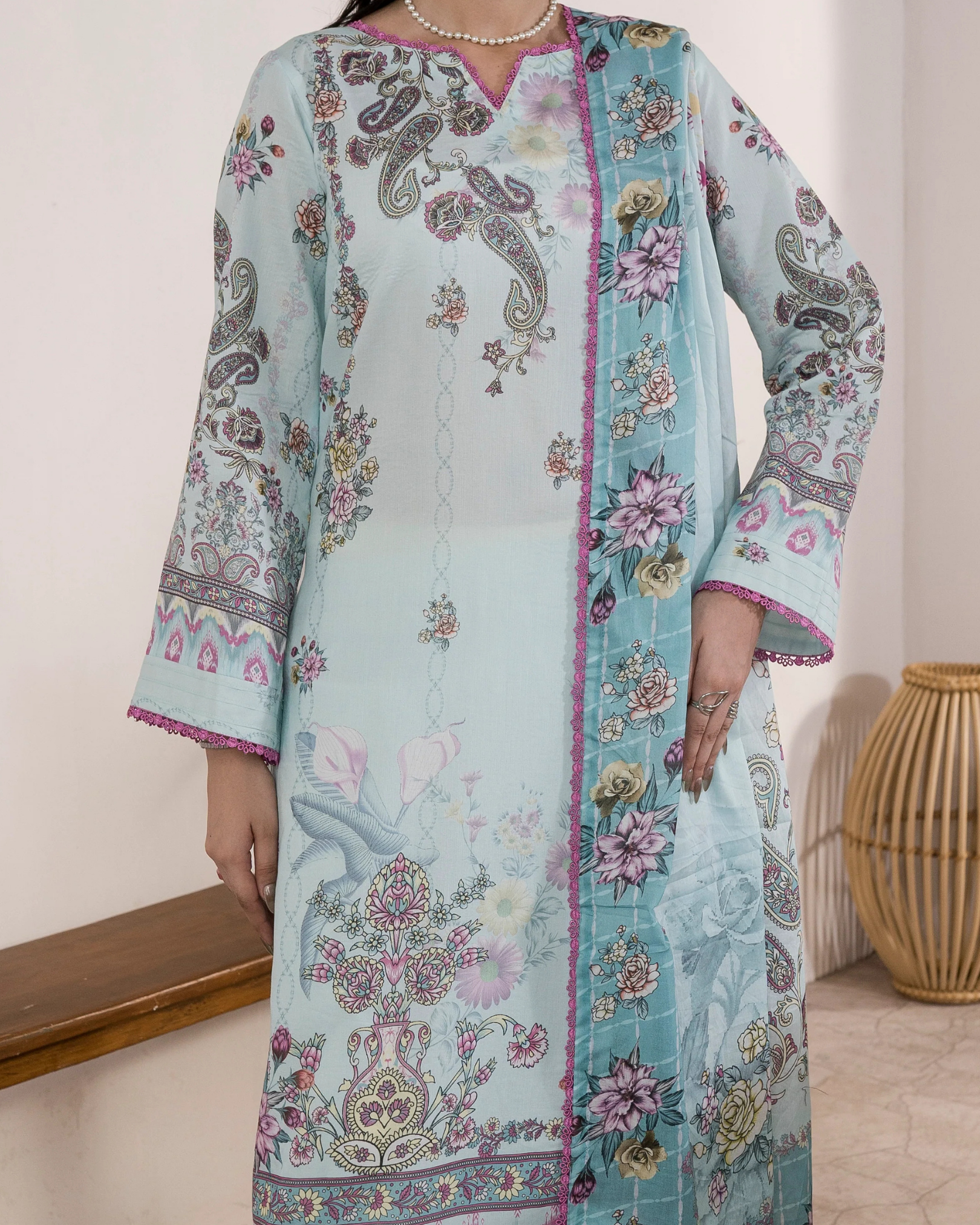 Colorful traditional outfit with floral patterns on a wooden floor