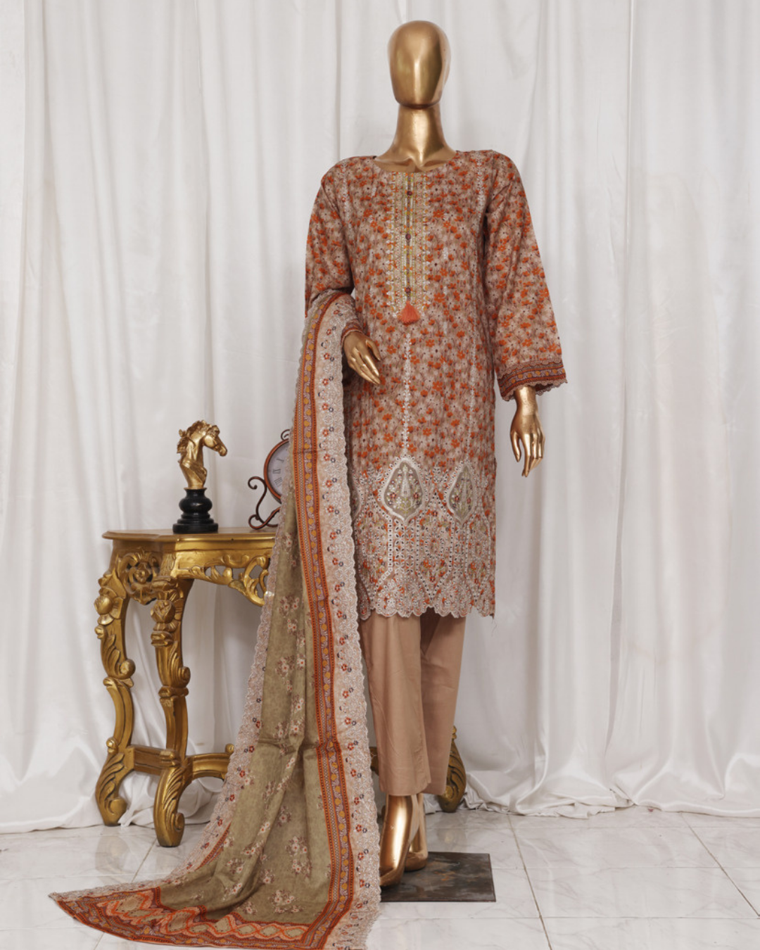 Mannequin wearing a traditional outfit with a floral pattern against a white curtain background.