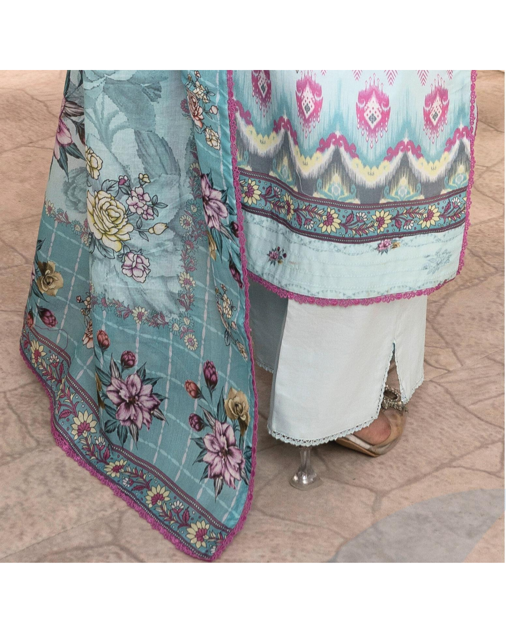 Colorful traditional outfit with floral patterns on a wooden floor