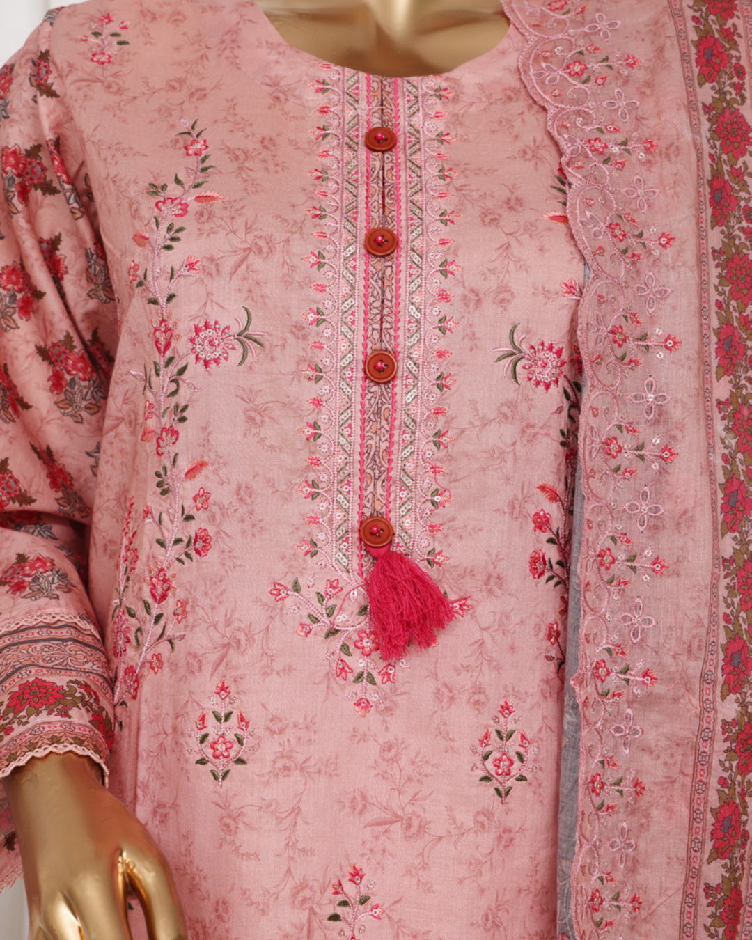 Pink embroidered garment on a mannequin with floral patterns