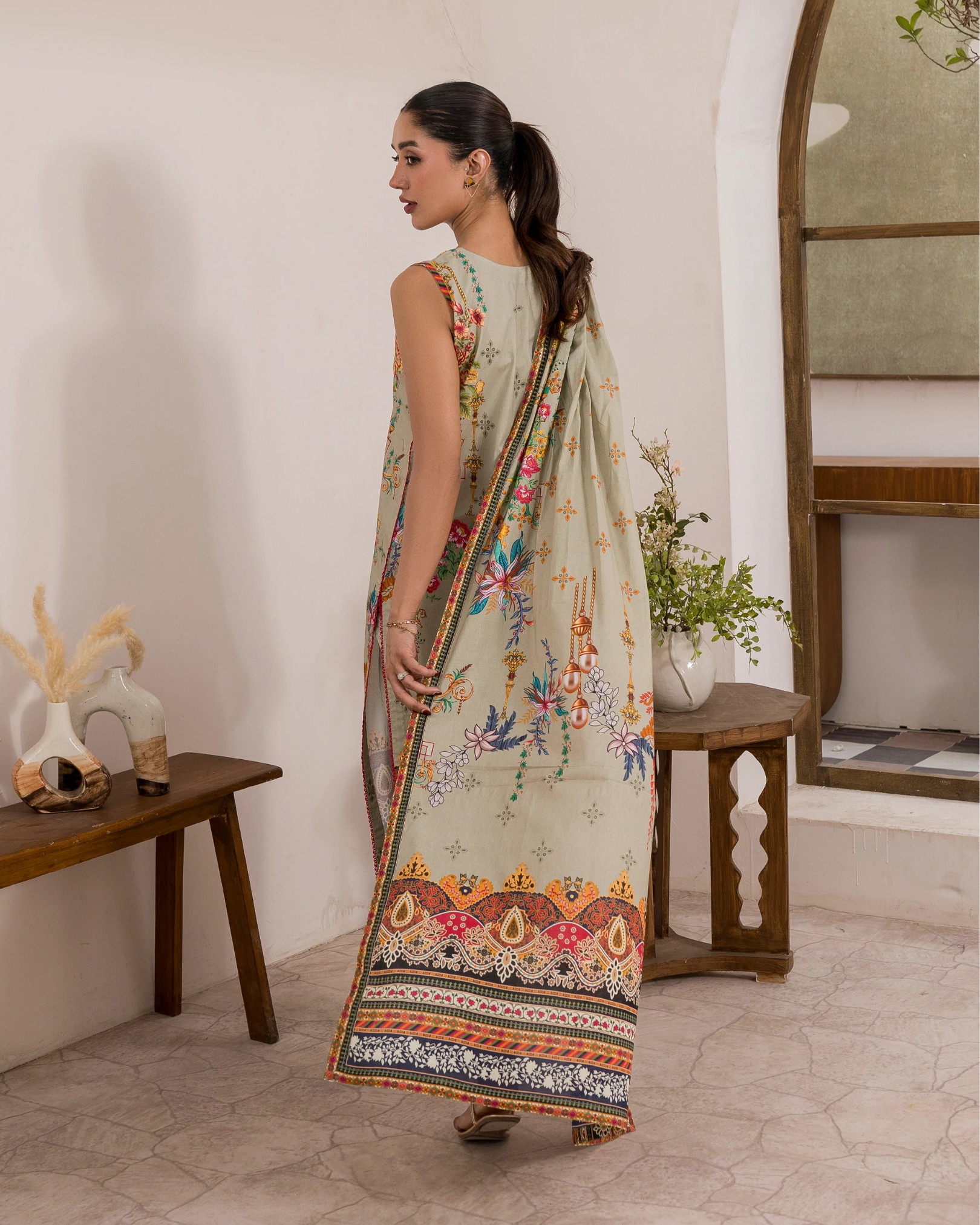 Woman wearing a traditional saree in a home setting