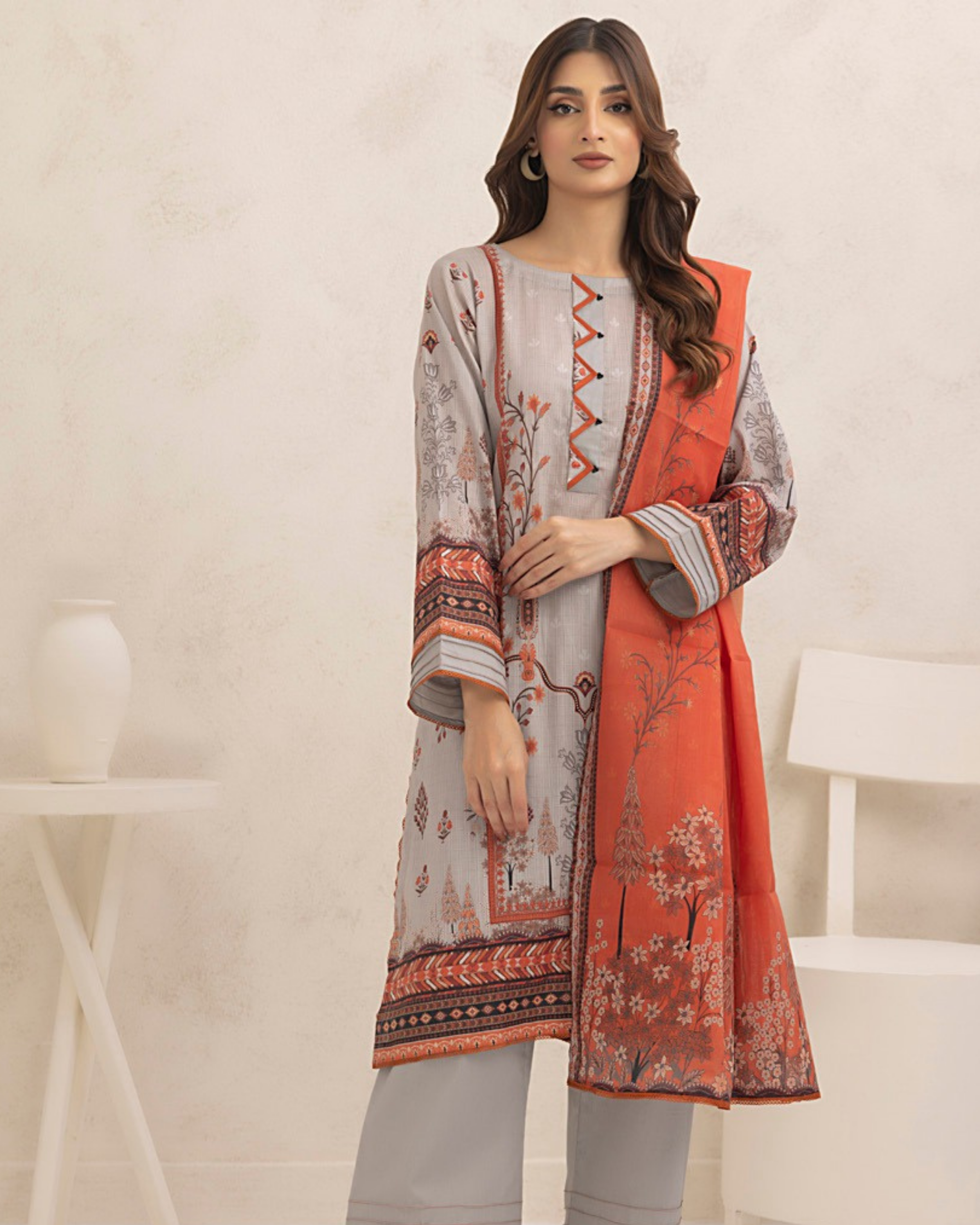 Woman wearing a patterned outfit with a neutral background