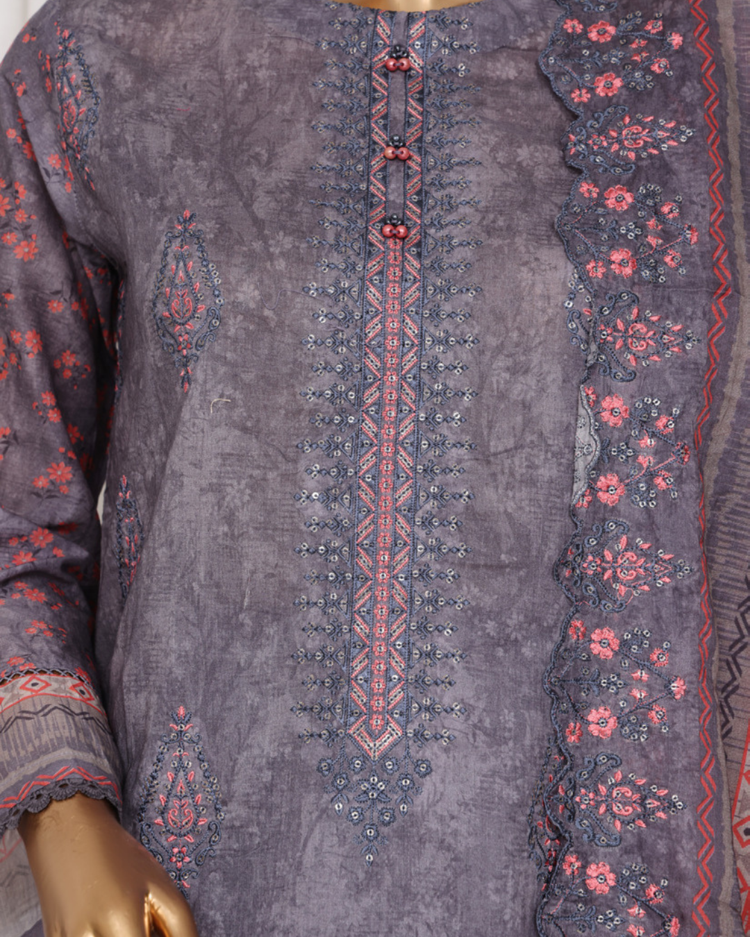 Embroidered garment with intricate patterns on a mannequin