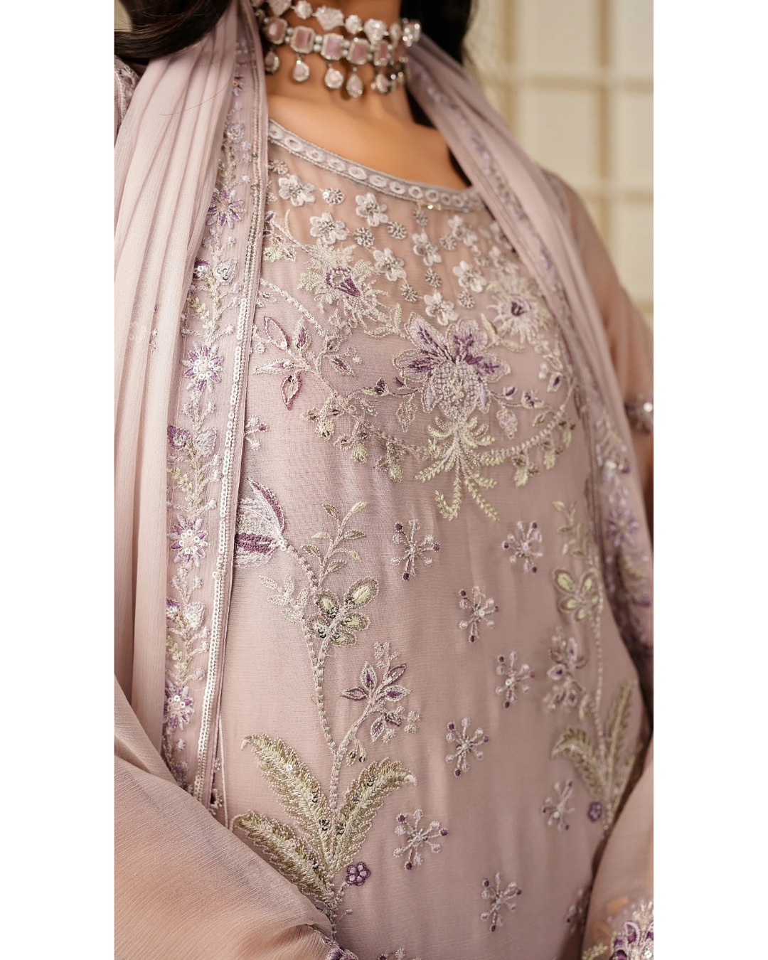Embroidered traditional outfit with a matching dupatta on a neutral background