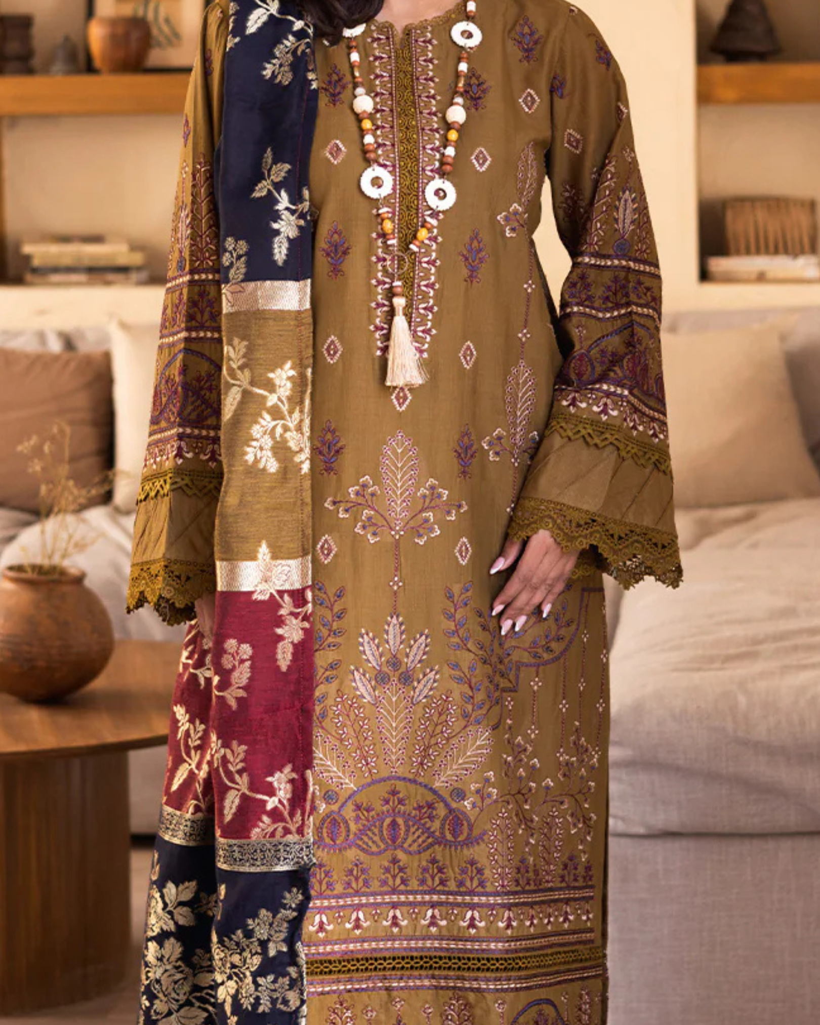 Traditional embroidered outfit with a living room background