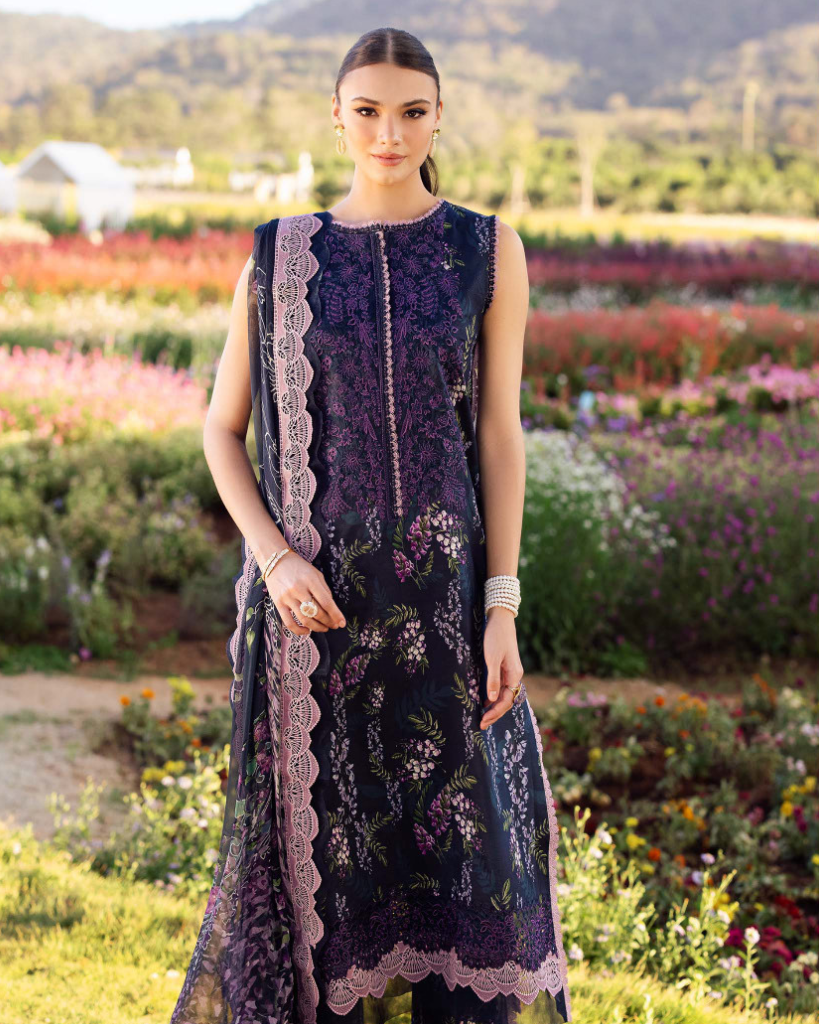 Woman wearing a dark floral dress in a garden setting