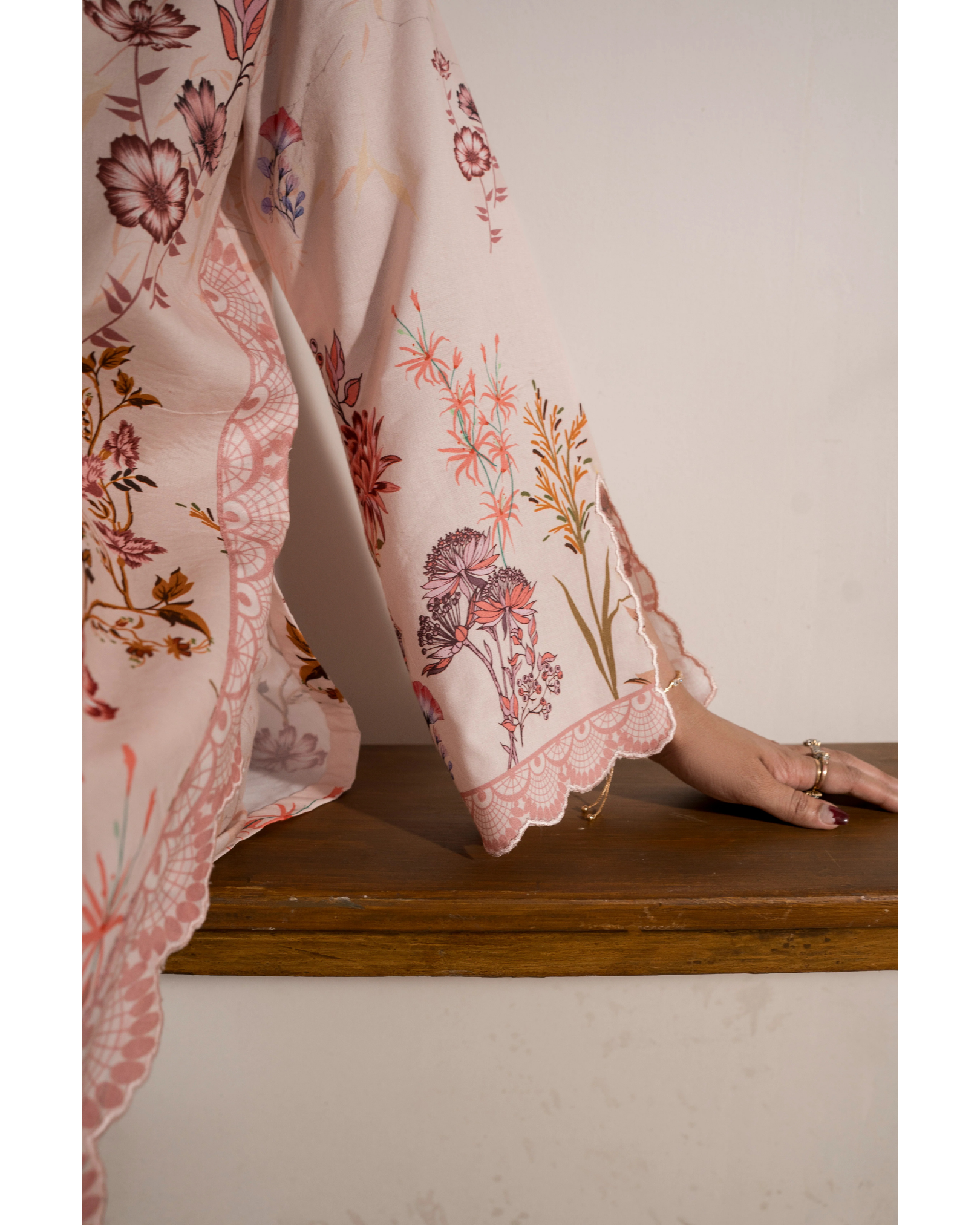 Floral-patterned fabric draped over a surface with a neutral background