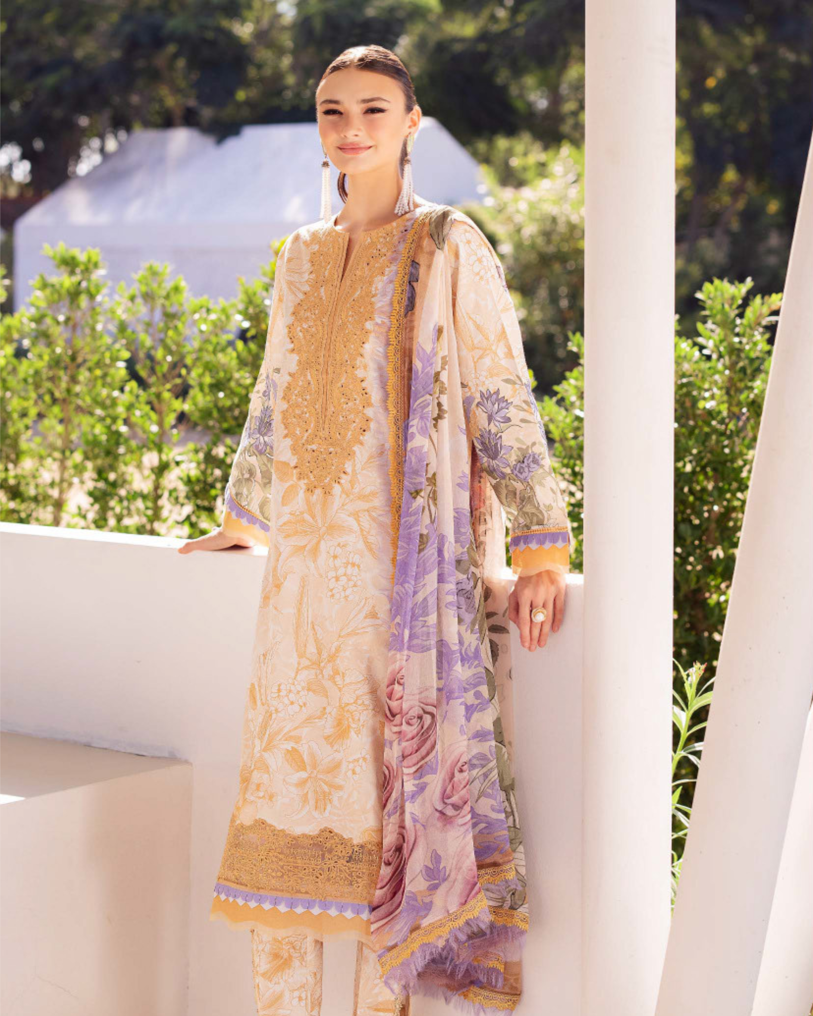 Woman wearing a patterned dress with a blurred outdoor background
