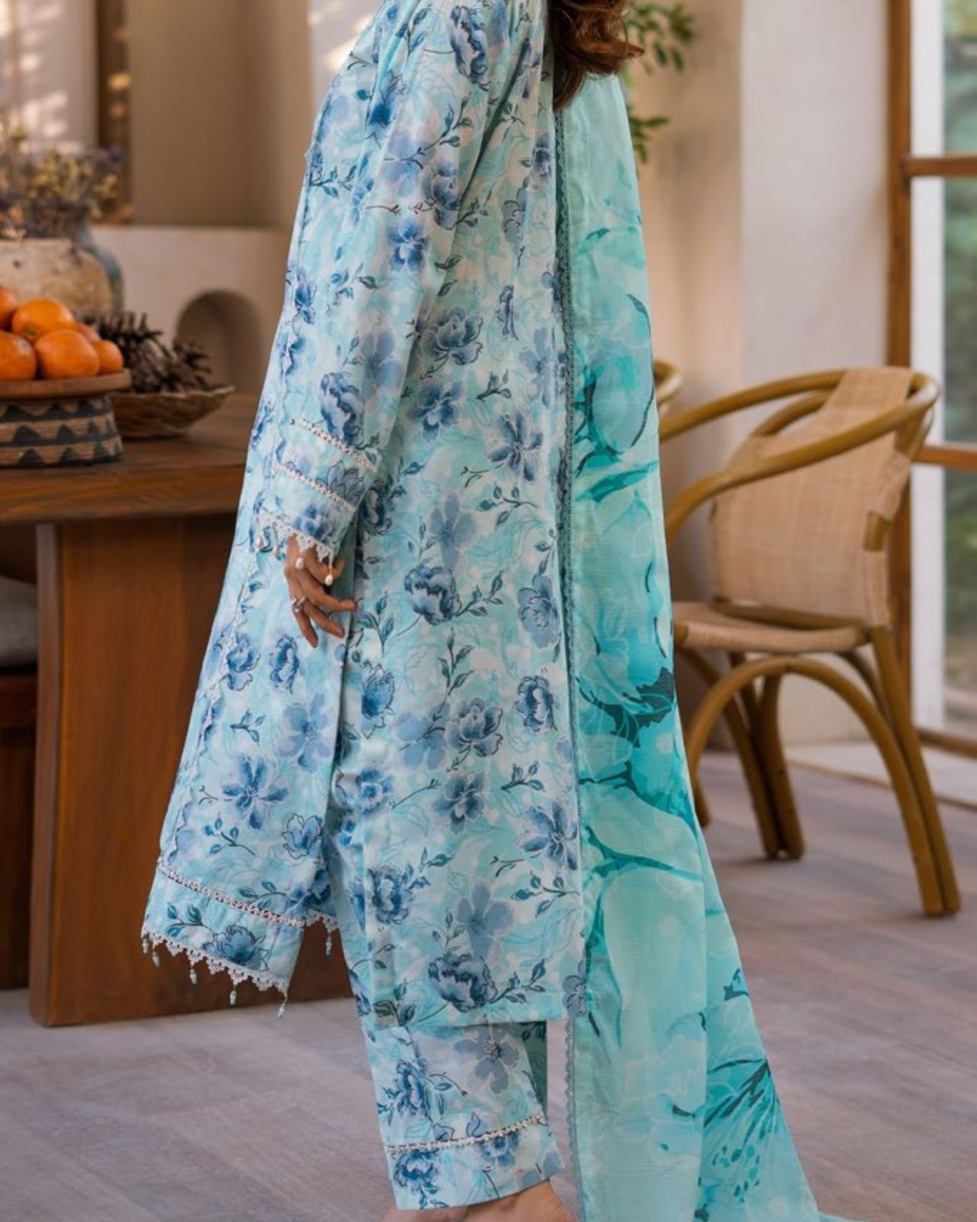 Person wearing a light blue floral outfit in an indoor setting