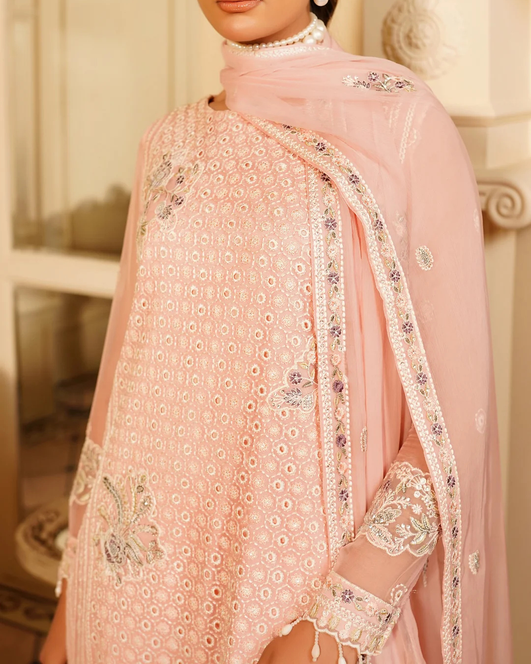 Pink embroidered traditional outfit with a matching dupatta.