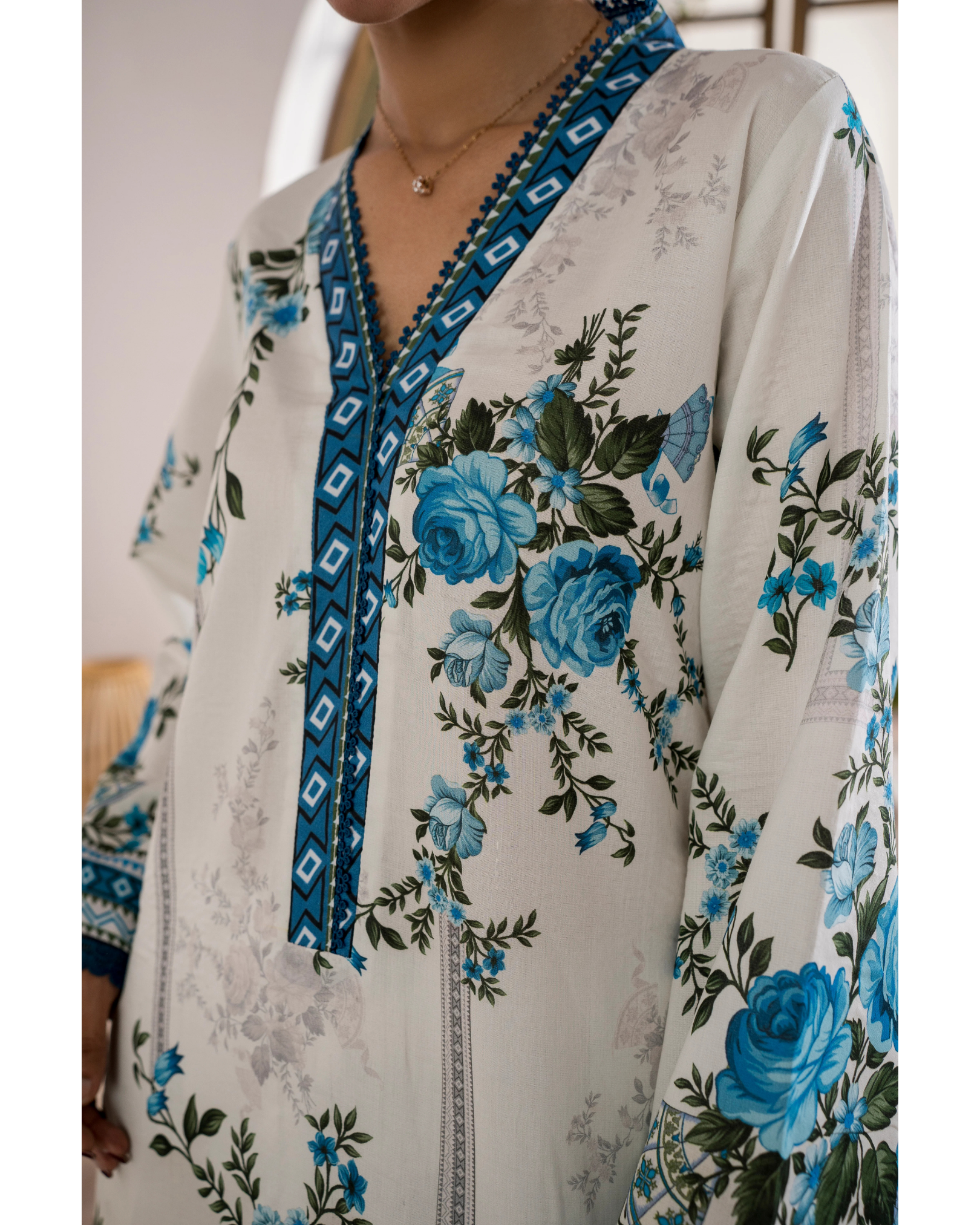 Floral patterned garment with blue roses on a light background