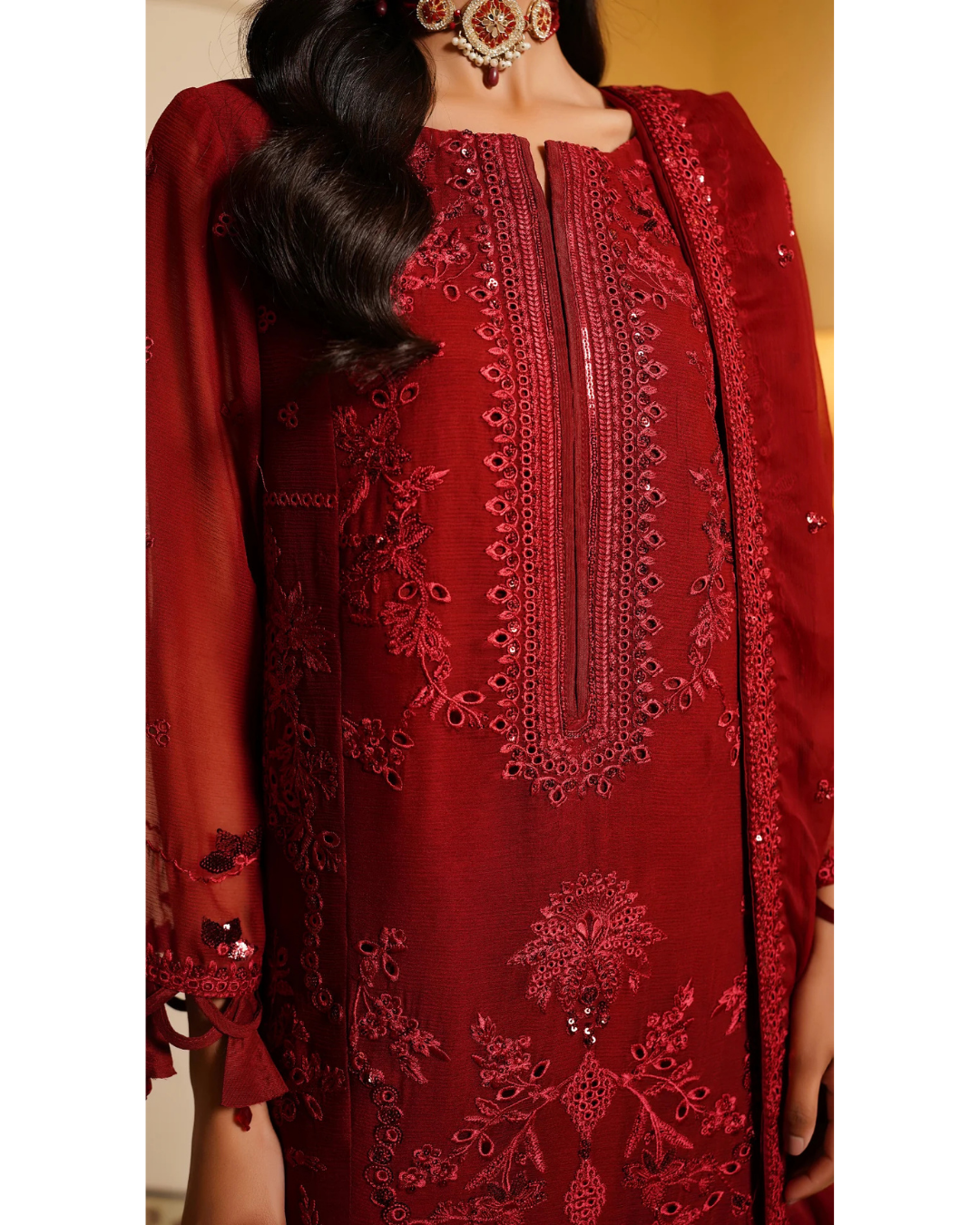 Red embroidered traditional outfit with intricate patterns