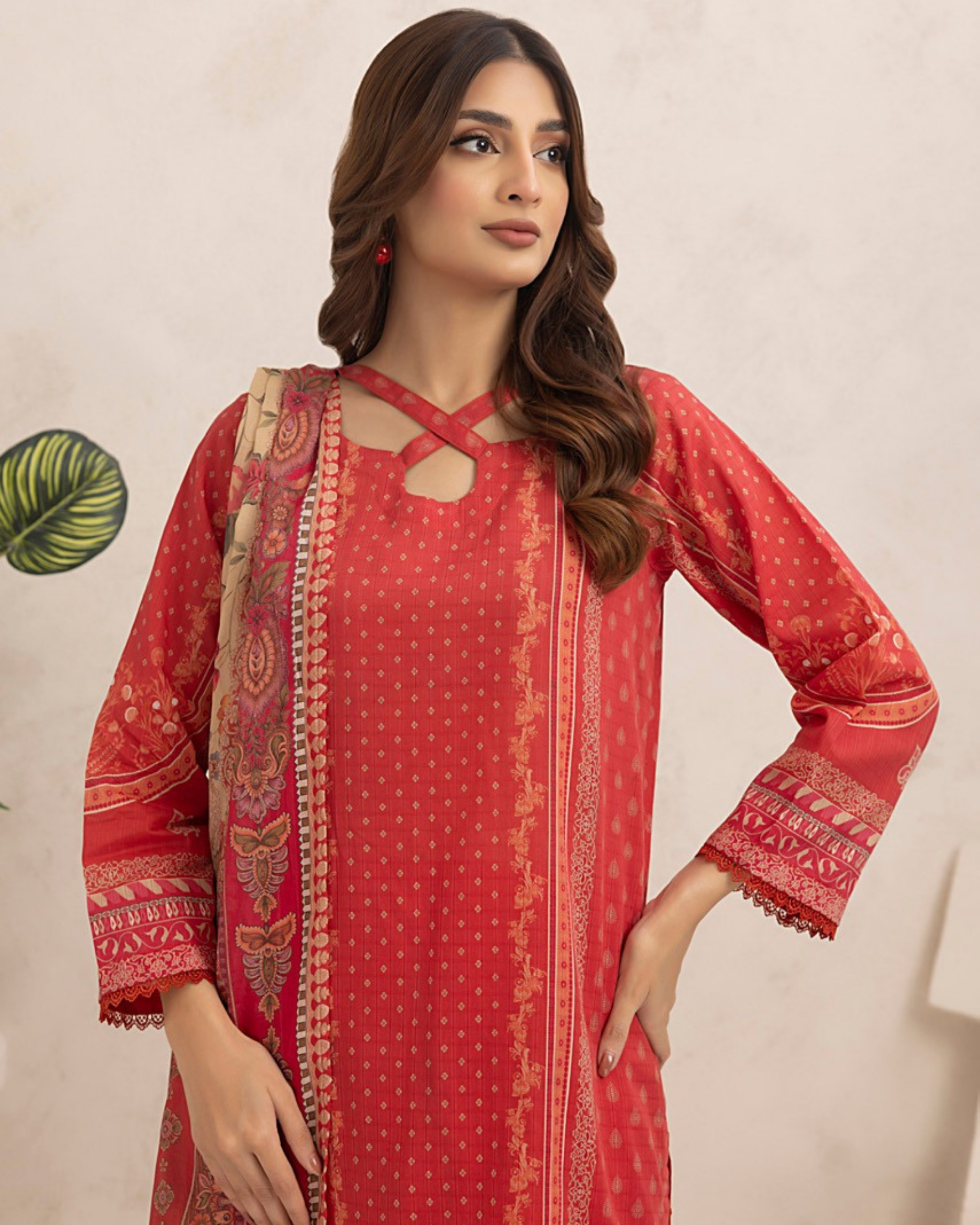 Woman wearing a red traditional outfit with a beige background
