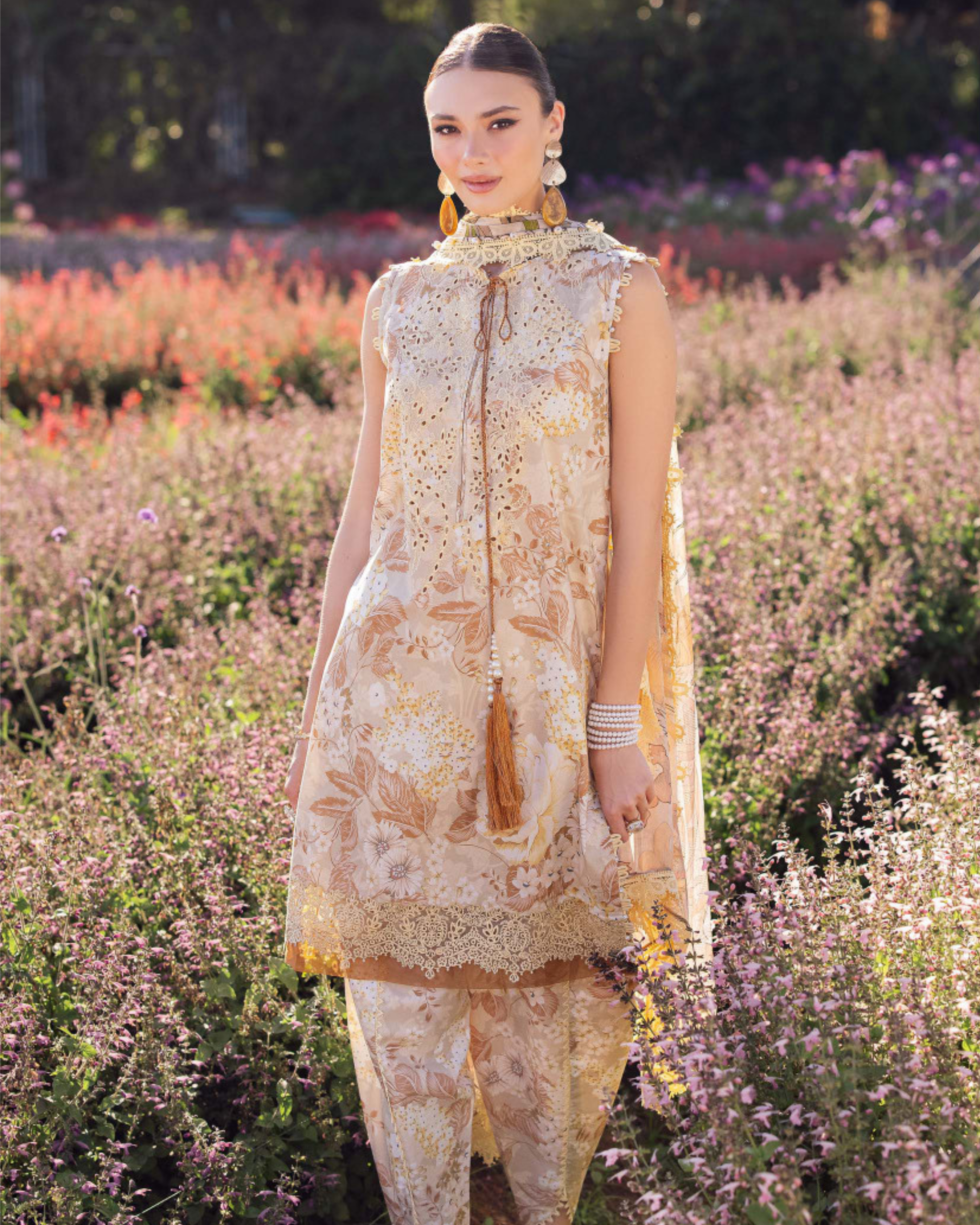 Woman in a floral dress standing in a field of flowers