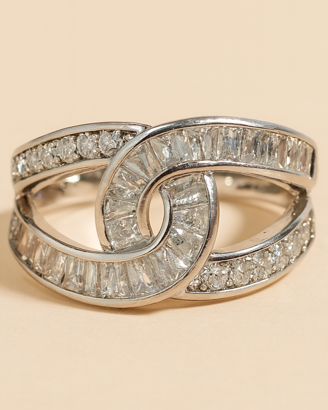 Silver ring with diamond accents on a beige background