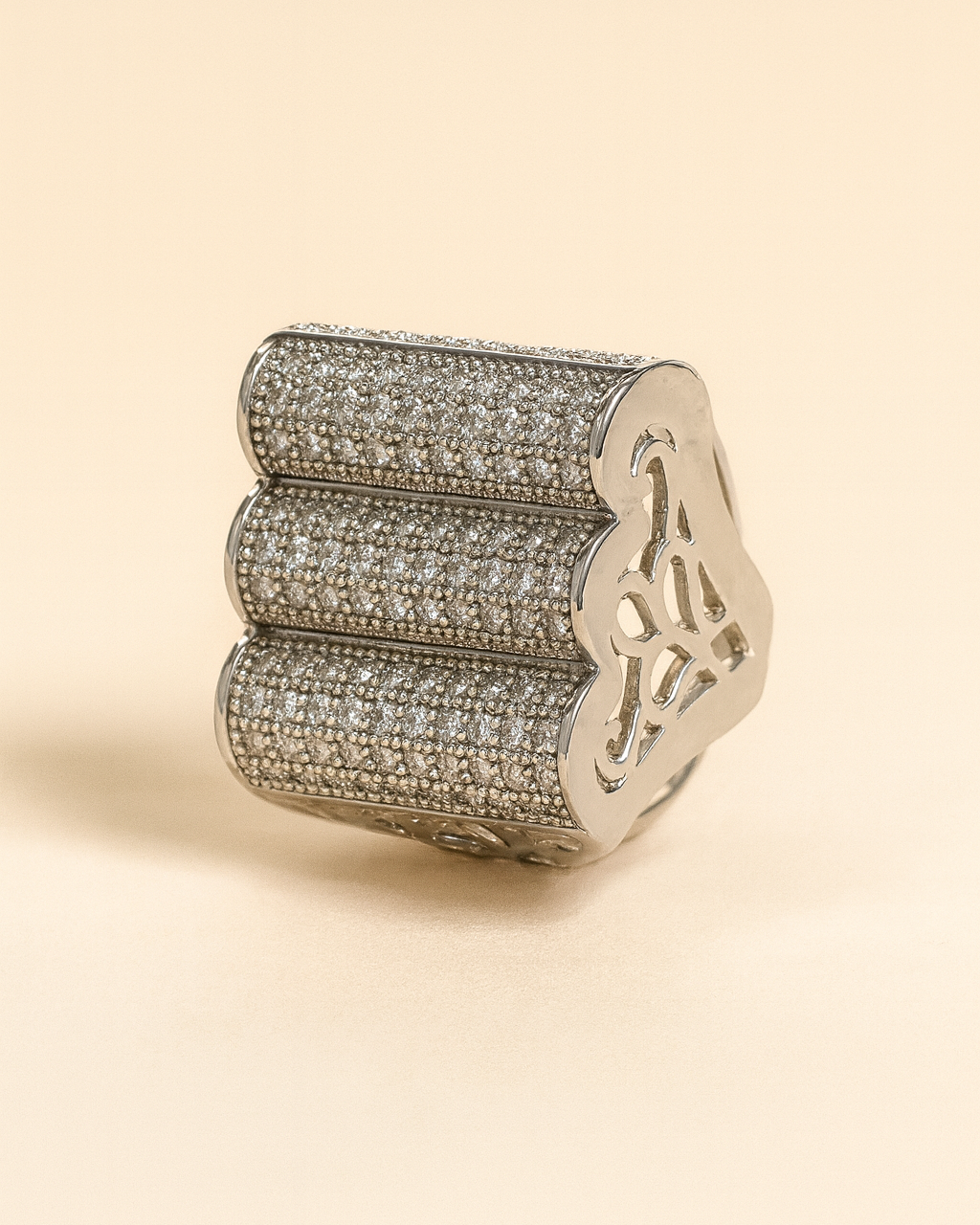 Decorative ring with intricate design on a beige background