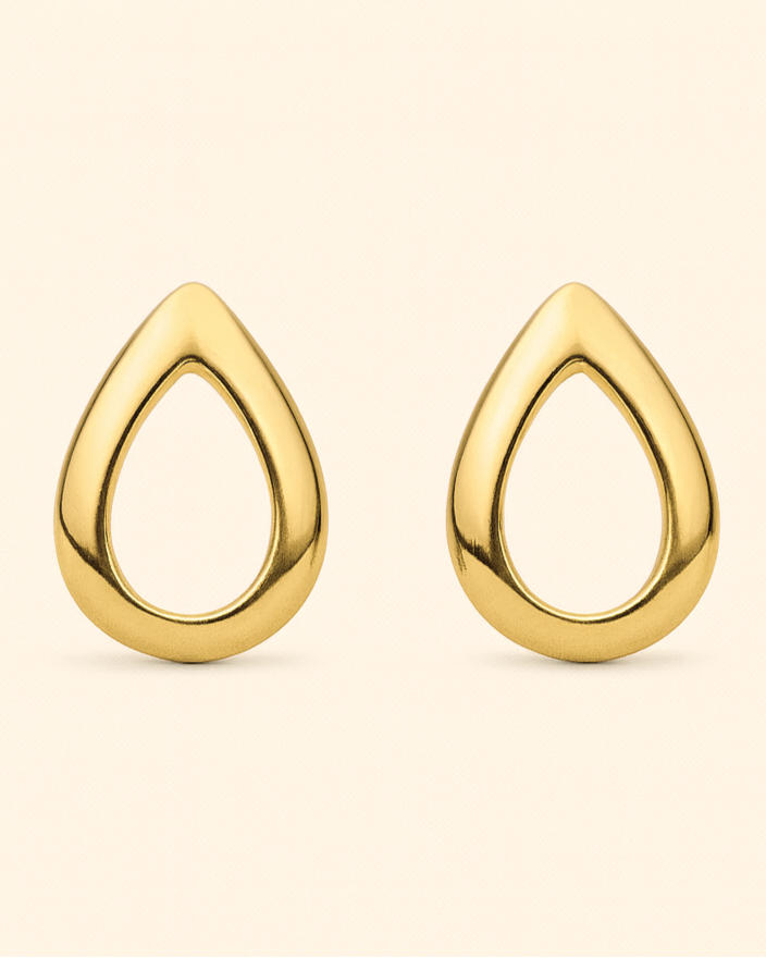 Gold teardrop earrings on a beige background