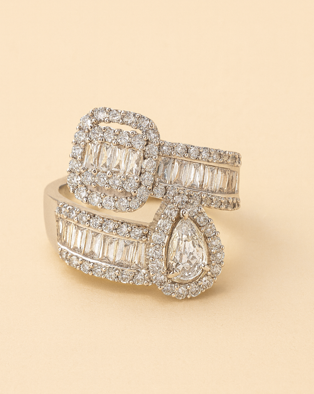 Gold ring with diamond accents on a beige background