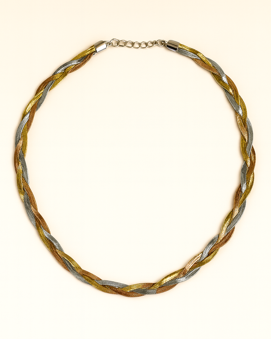 Braided necklace with gold and silver tones on a white background