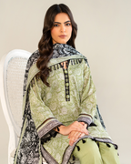 Woman wearing a green traditional outfit with a matching dupatta on a plain background