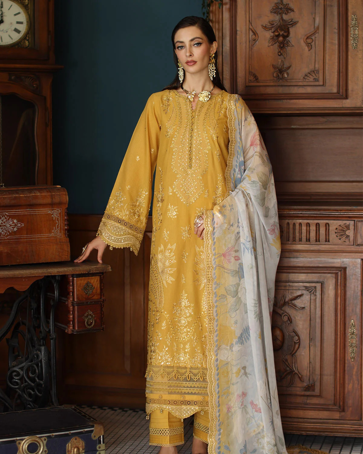Woman in a yellow embroidered outfit with a floral shawl in a vintage interior setting