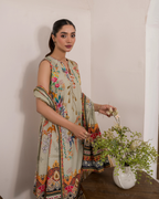 Woman in a floral dress holding flowers indoors