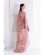 Woman wearing a pink floral dress against a white background