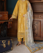 Person wearing a mustard yellow embroidered outfit with a floral dupatta in a vintage setting.