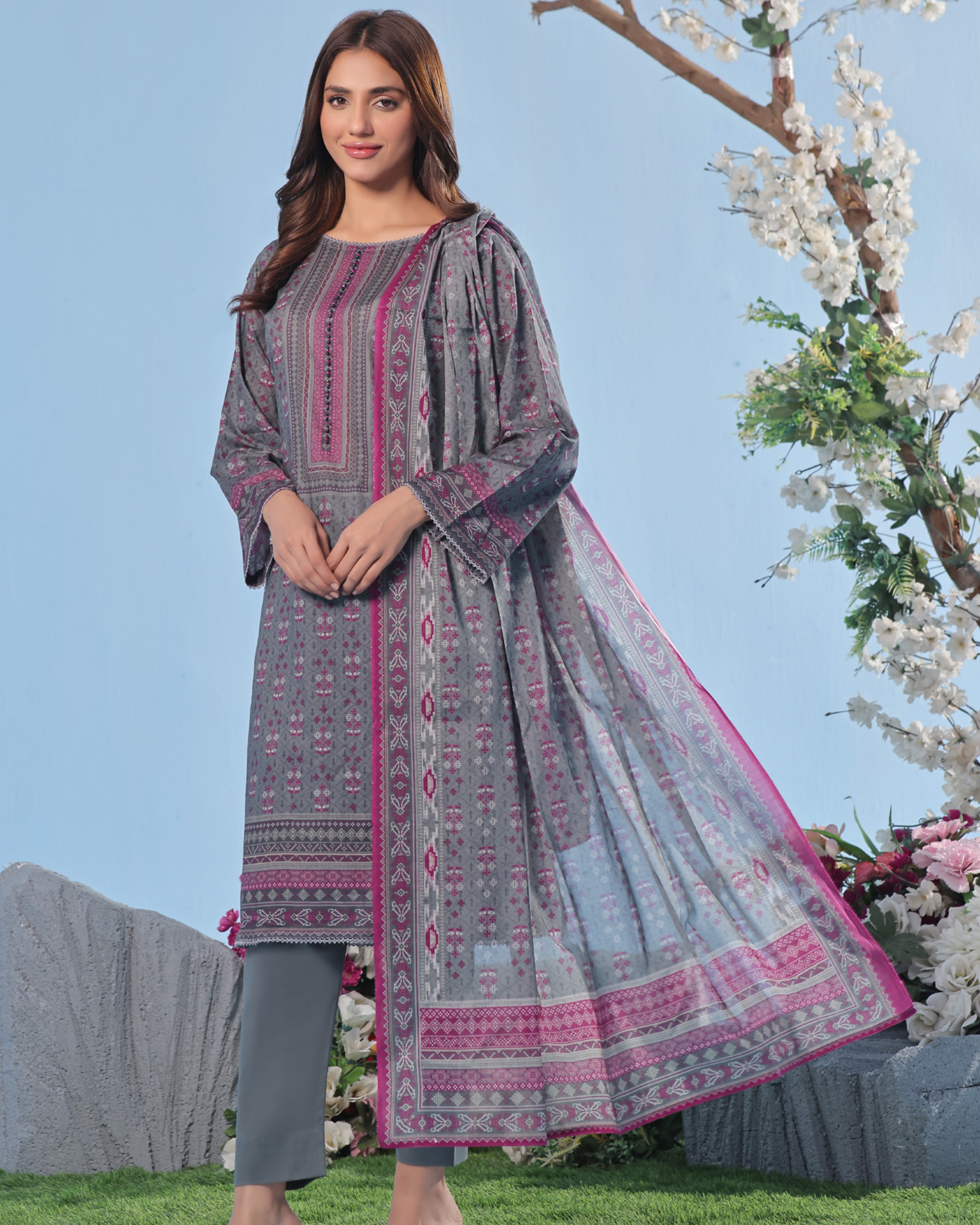 Woman wearing a patterned dress with a floral background