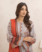Woman wearing a traditional outfit with a red and white patterned jacket against a beige background