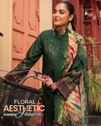 Woman in green traditional outfit with a colorful scarf, standing next to a bicycle in an outdoor setting.