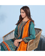 Woman sitting on a wicker chair wearing a green and orange traditional outfit with a blue background