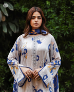 Woman wearing a floral-patterned outfit with a green leafy background