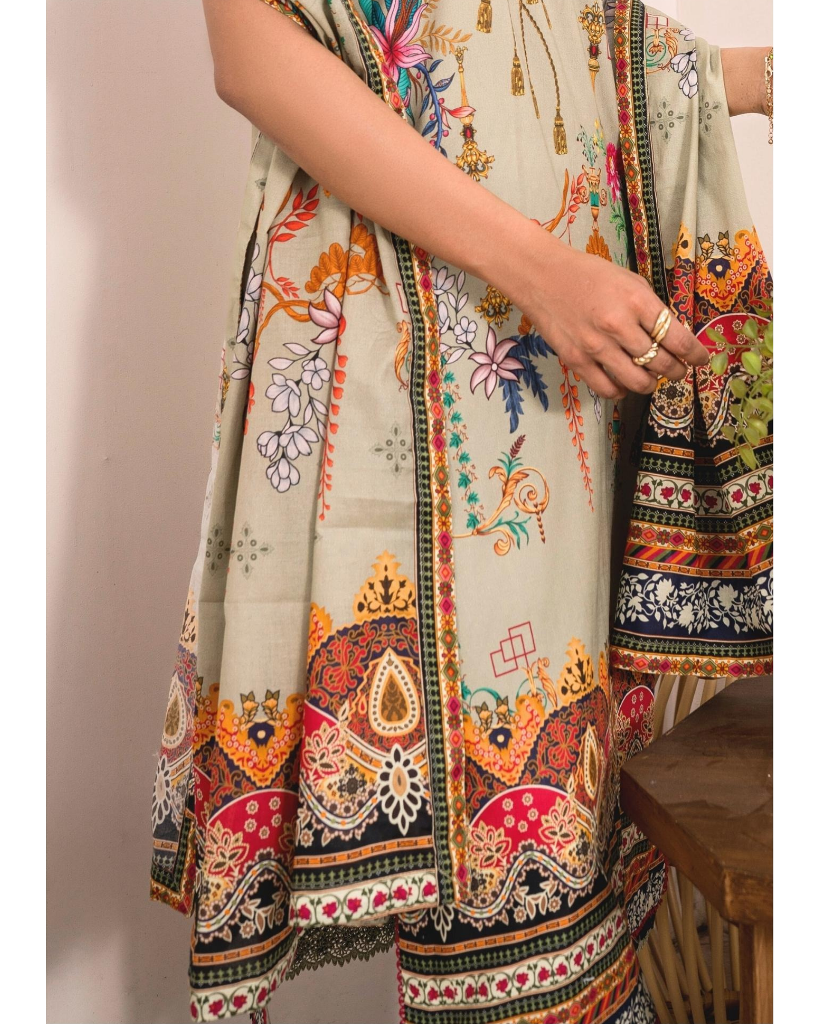 Traditional outfit with colorful patterns on a neutral background