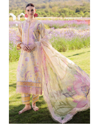 Woman in a traditional outfit with a floral pattern standing in a field of flowers.
