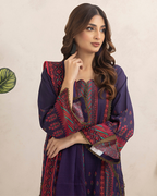 Woman wearing a purple traditional outfit with intricate patterns on a beige background