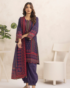Woman wearing a traditional outfit with intricate patterns on a beige background, featuring the brand 'Ala Raasi'.