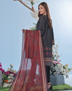 Woman holding a red patterned dupatta with floral decorations in the background