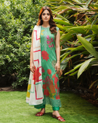 Woman in a green floral dress standing in a garden