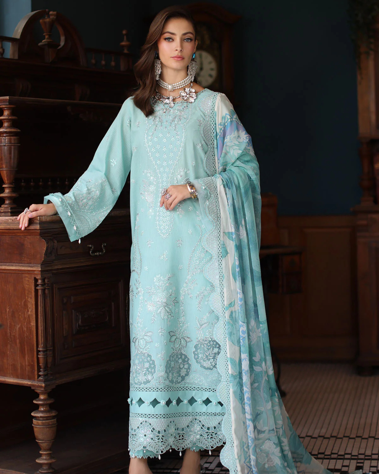 Woman wearing a light blue embroidered dress in an indoor setting