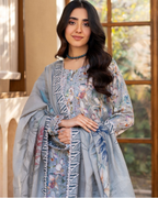 Woman wearing a floral dress with a matching shawl indoors