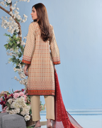 Woman wearing a beige and red traditional outfit with a floral arrangement and light blue background