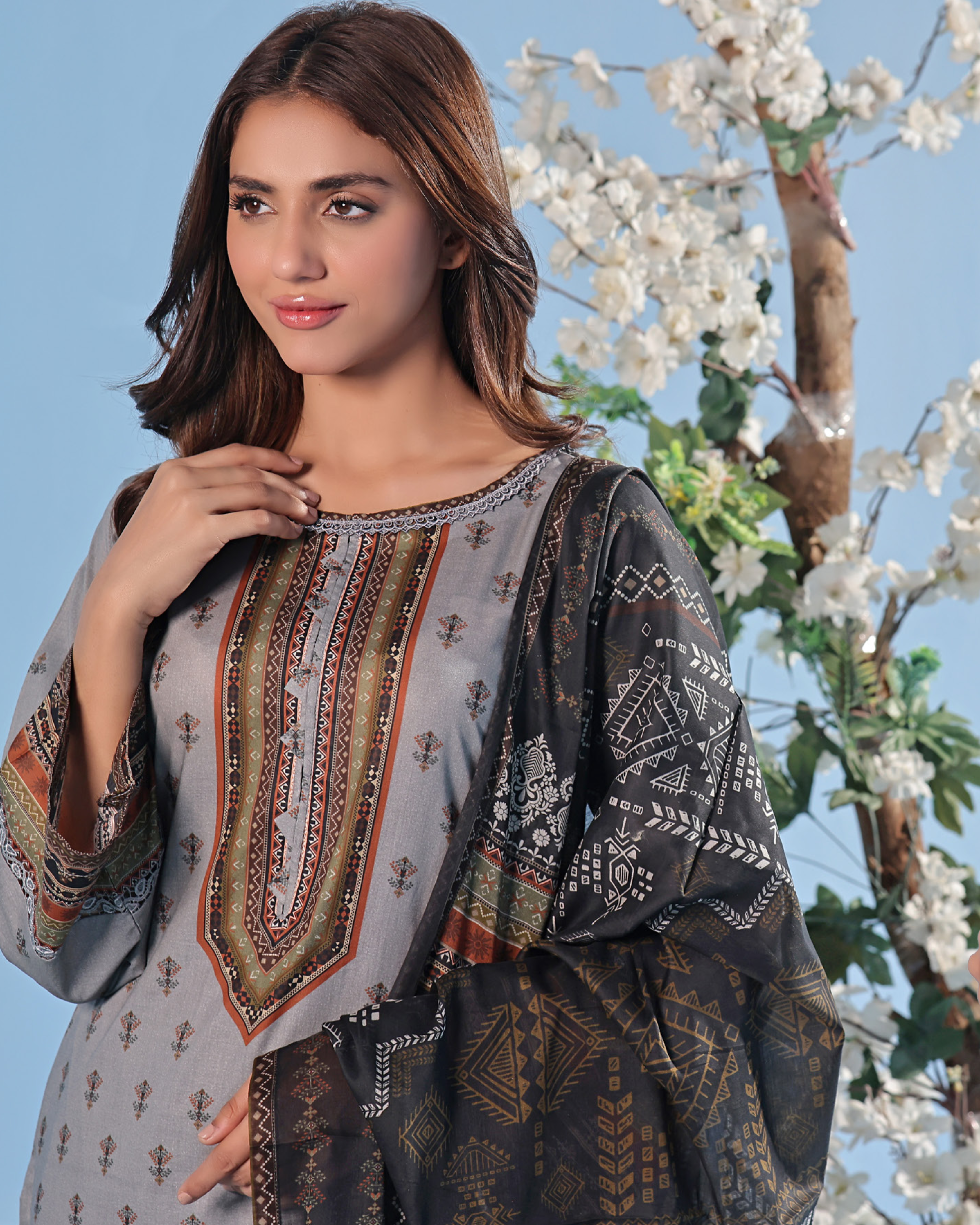 Woman wearing a traditional outfit with floral background