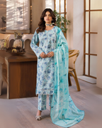 Woman in a light blue floral outfit with a matching dupatta in an indoor setting.