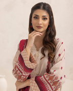 Woman wearing a traditional outfit with red and white patterns on a plain background