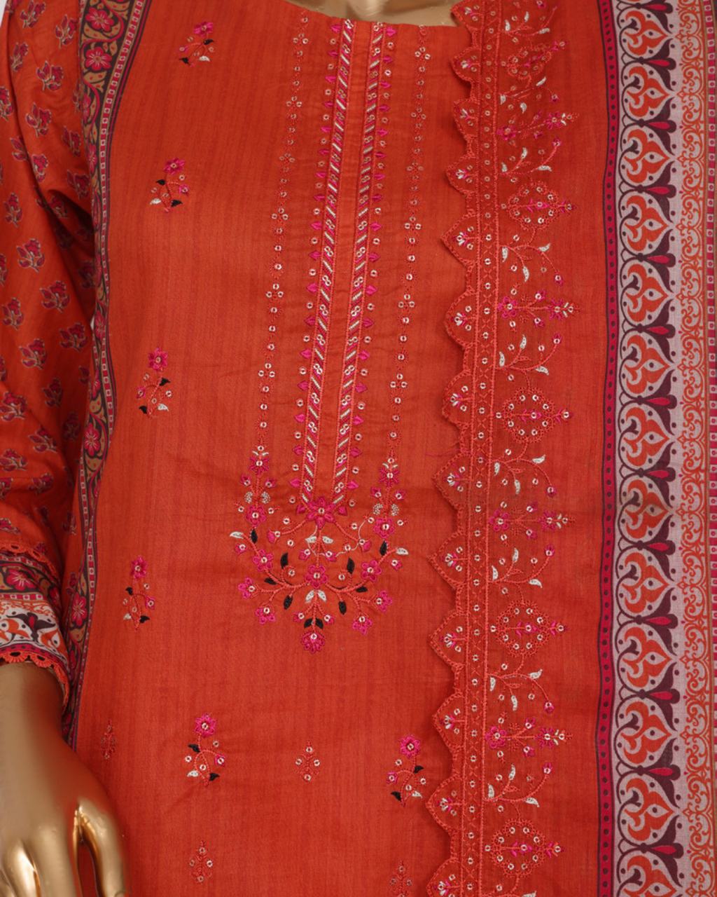 Red embroidered fabric with intricate patterns on a mannequin
