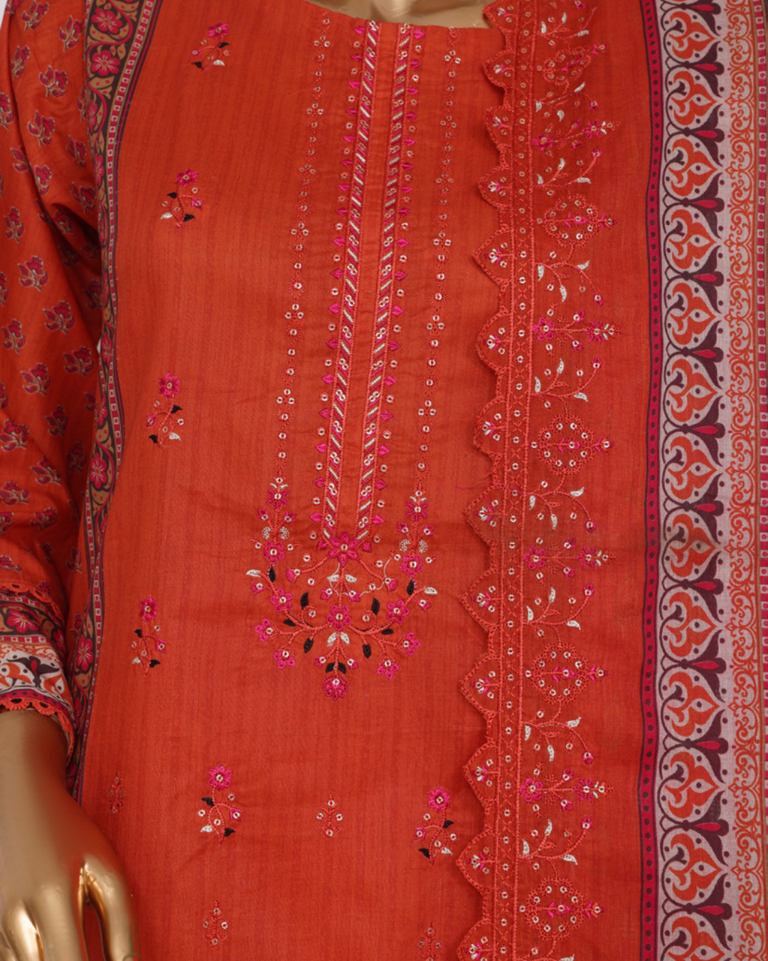 Red embroidered fabric with intricate patterns on a mannequin
