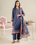 Woman wearing a blue embroidered outfit with a matching dupatta in a minimalistic setting.