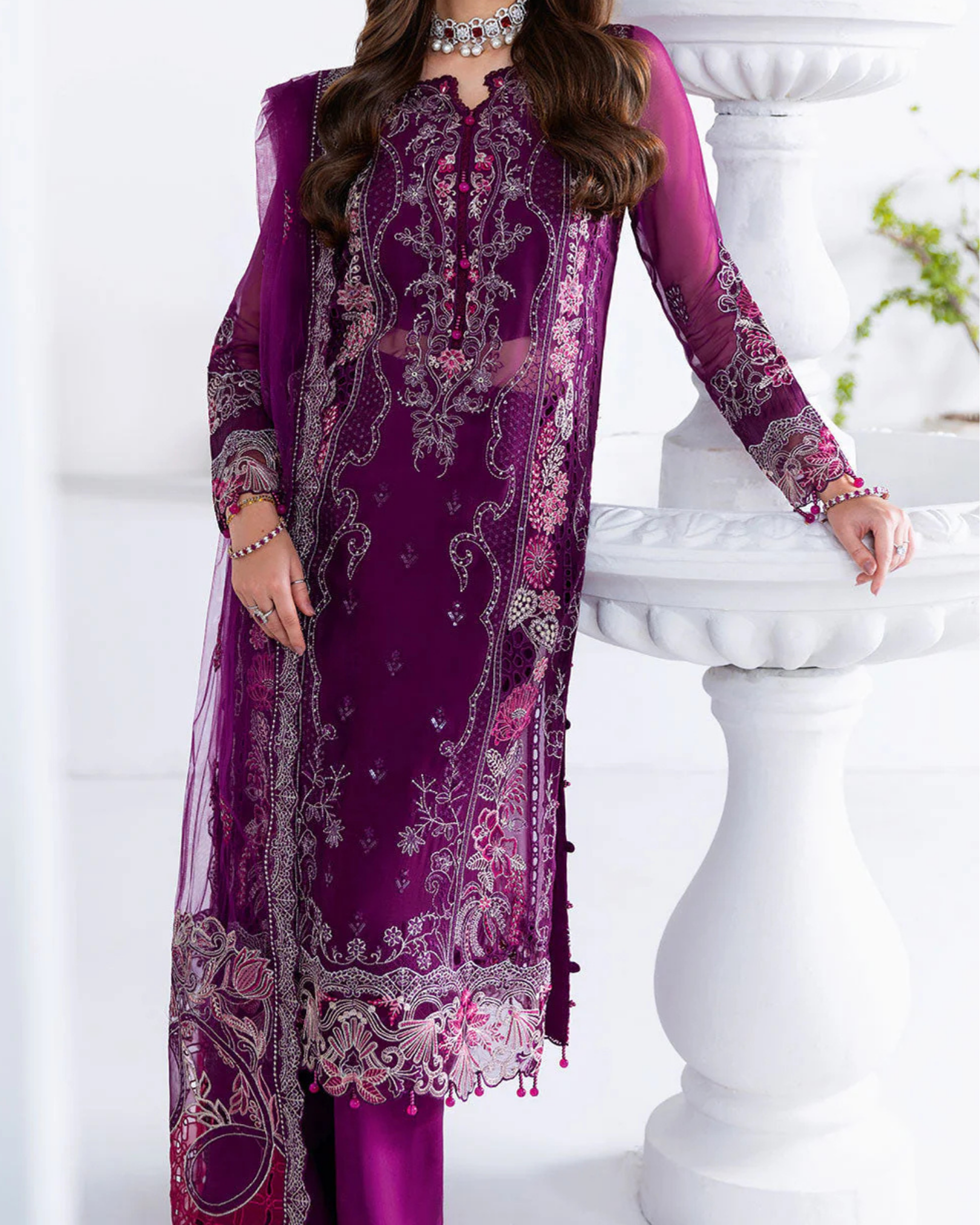 Purple embroidered traditional outfit with a white background