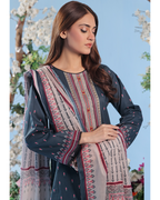 Woman wearing a patterned dress with a blue background